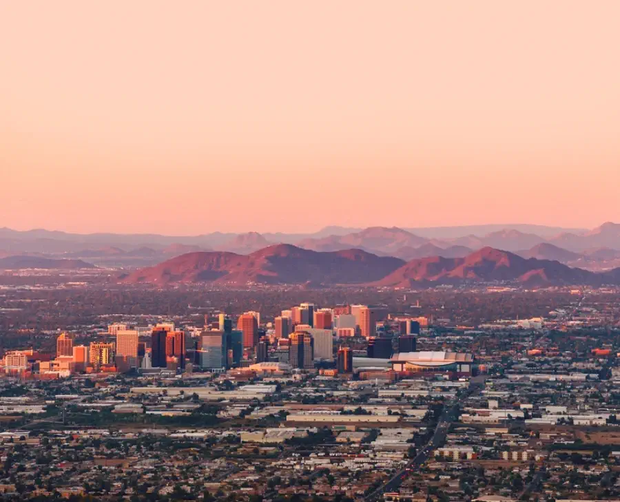 Phoenix with its downtown lit by the last rays of sun at the dusk.